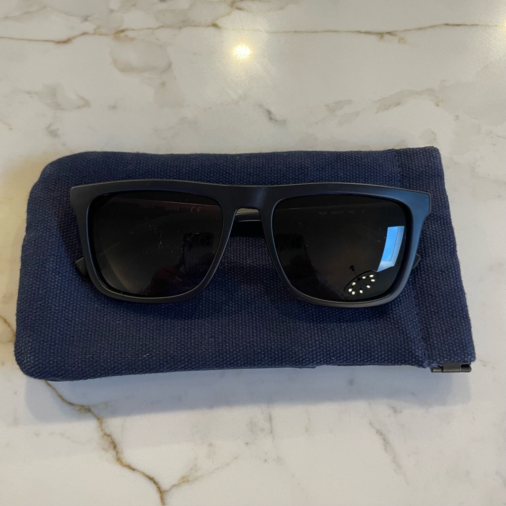 Guess sunglasses. Navy blue frames with metal arms and signature G on sides.